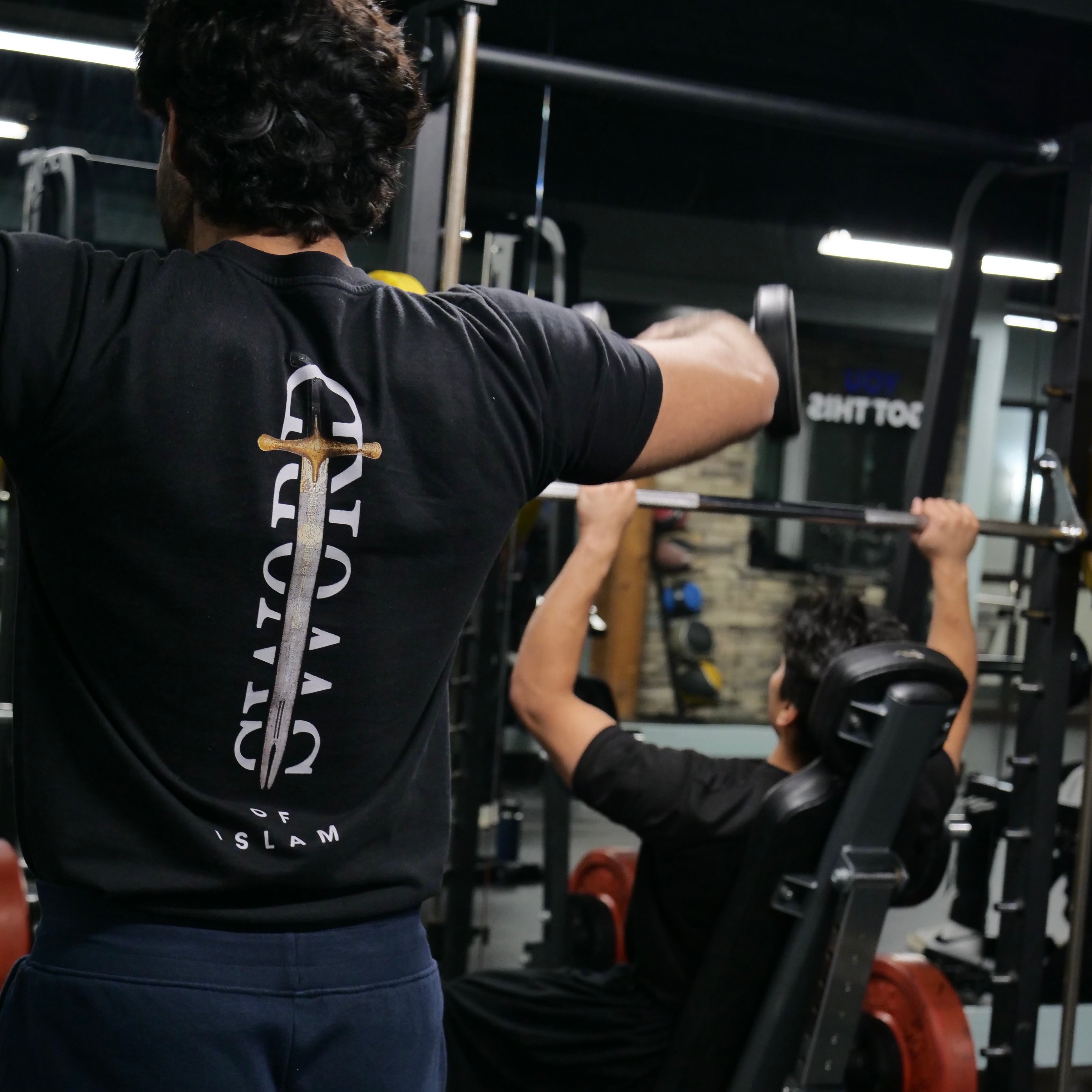 Back graphic of t-shirt showing bold Islamic sword design